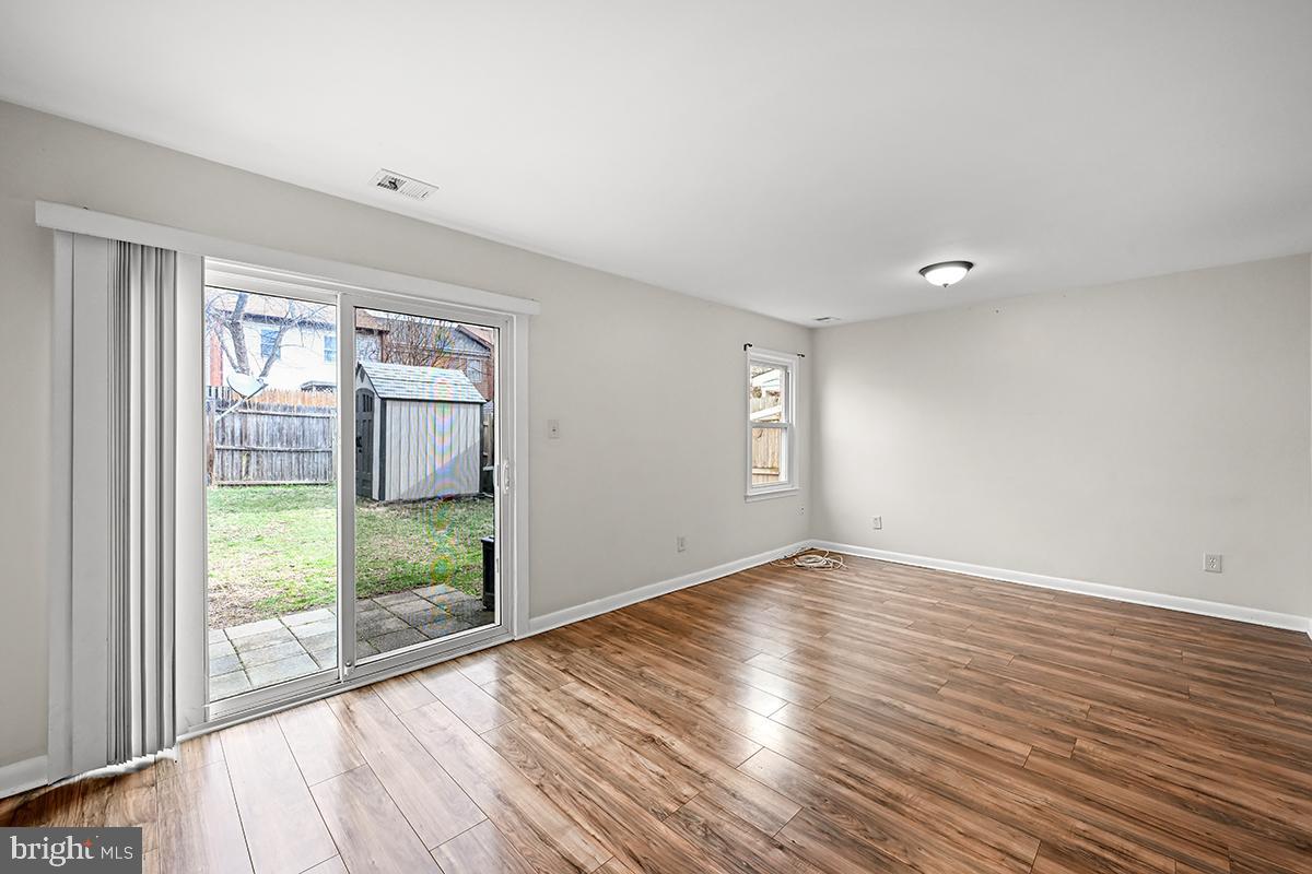 124 Marlow Street Southwest Leesburg, VA 20175 - Photo 15 of 37 a view of an empty room with wooden floor and a window