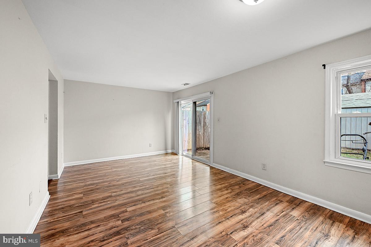 124 Marlow Street Southwest Leesburg, VA 20175 - Photo 16 of 37 a view of an empty room with wooden floor and a window