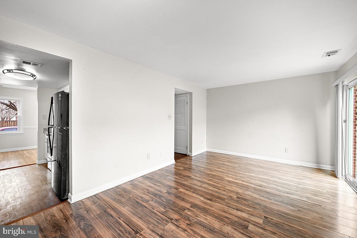 124 Marlow Street Southwest Leesburg, VA 20175 - Photo 17 of 37 a view of an empty room with wooden floor and a window