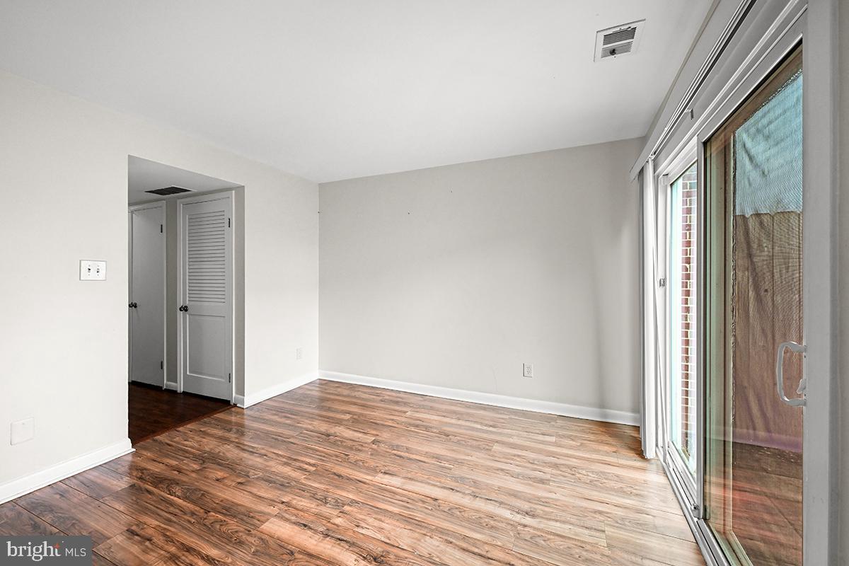 124 Marlow Street Southwest Leesburg, VA 20175 - Photo 18 of 37 a view of empty room with wooden floor and fan