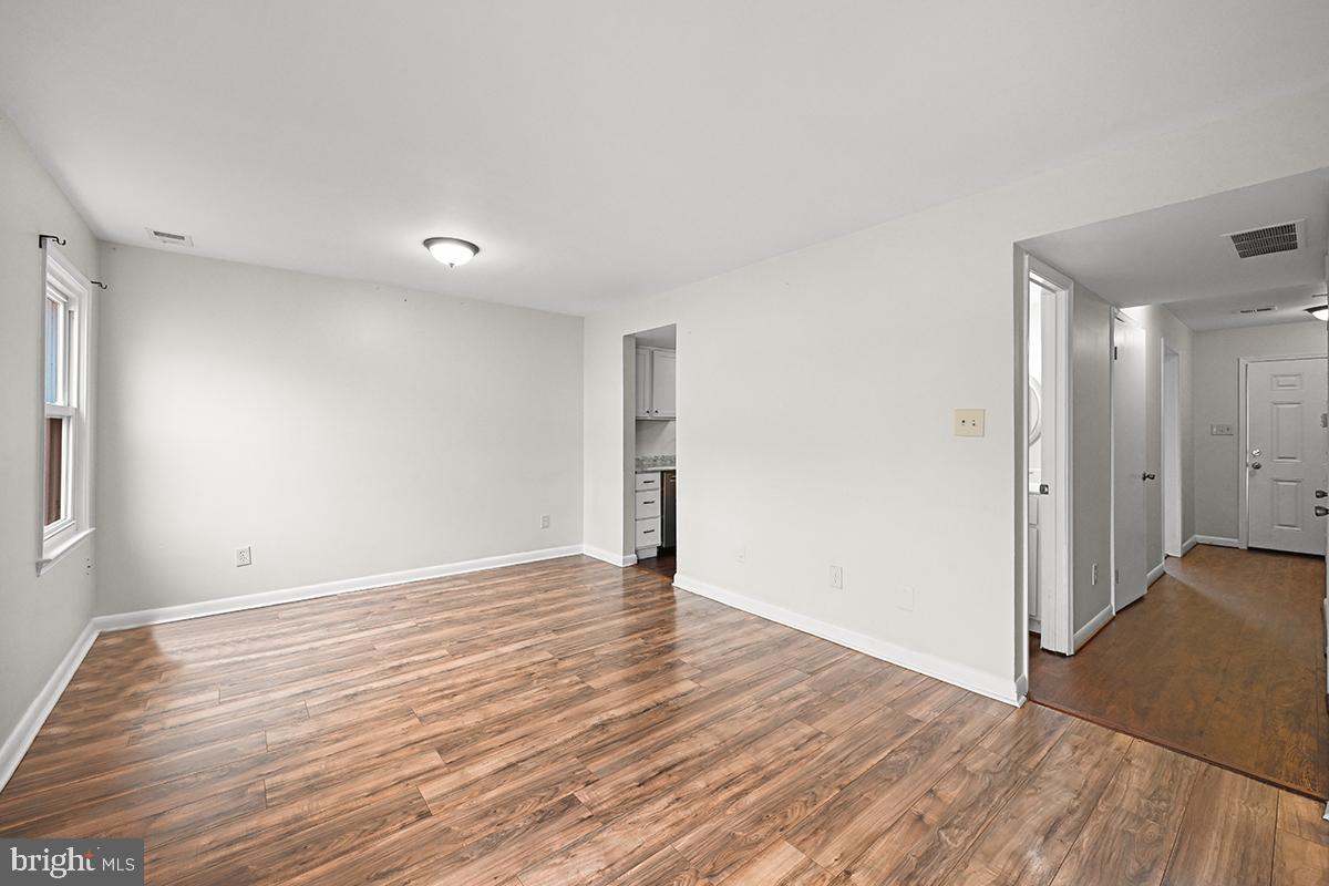 124 Marlow Street Southwest Leesburg, VA 20175 - Photo 19 of 37 a view of an empty room with wooden floor