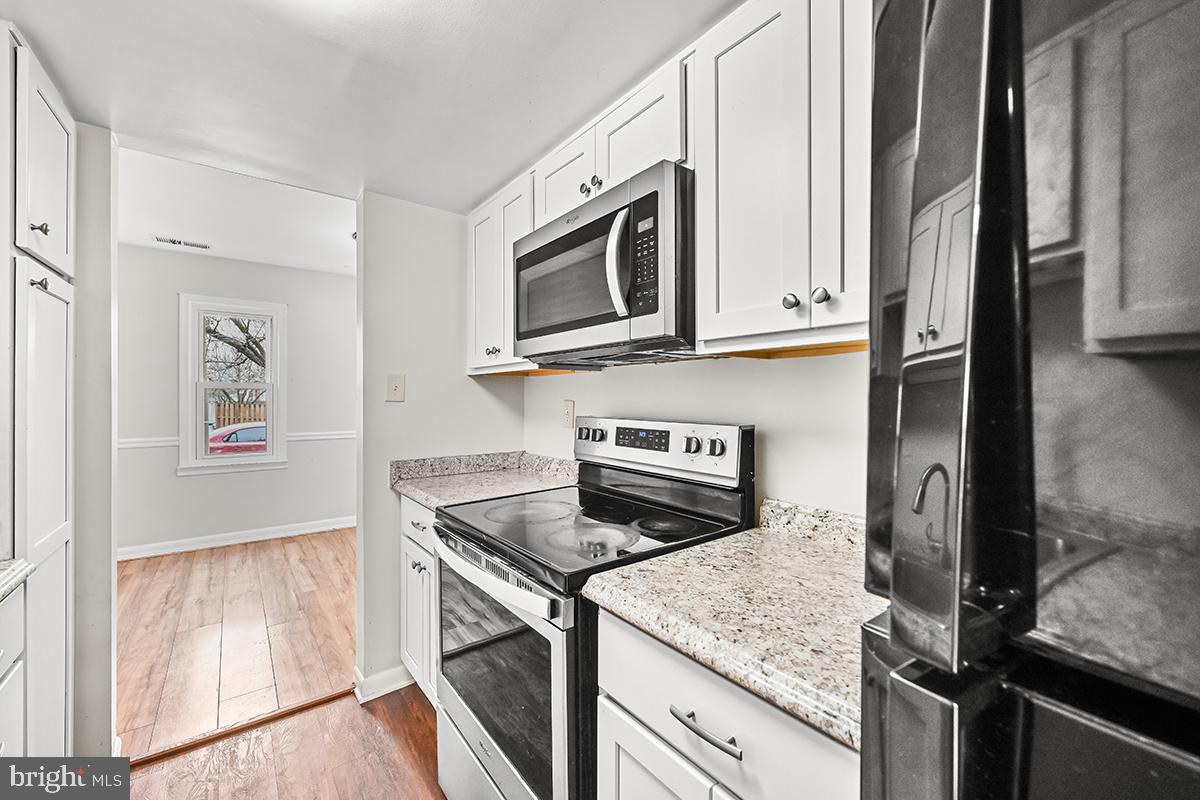 124 Marlow Street Southwest Leesburg, VA 20175 - Photo 10 of 37 a kitchen with granite countertop cabinets stainless steel appliances and a counter space