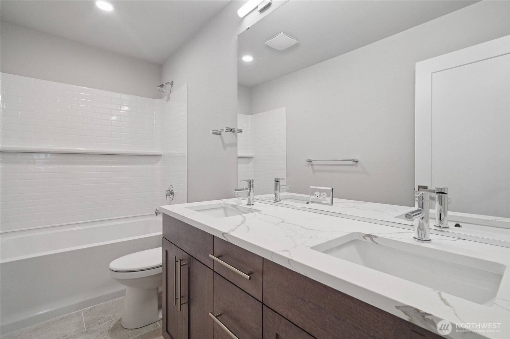 3822 194th Street Southeast Bothell, WA 98012 - Photo 16 of 29 a bathroom with a sink a toilet a mirror and shower