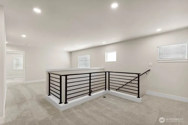 a view of an empty room with windows