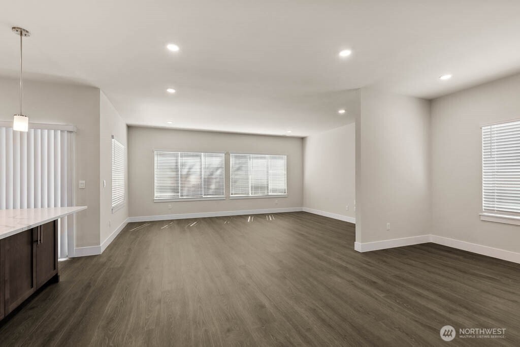 3822 194th Street Southeast Bothell, WA 98012 - Photo 7 of 33 an empty room with wooden floor and windows