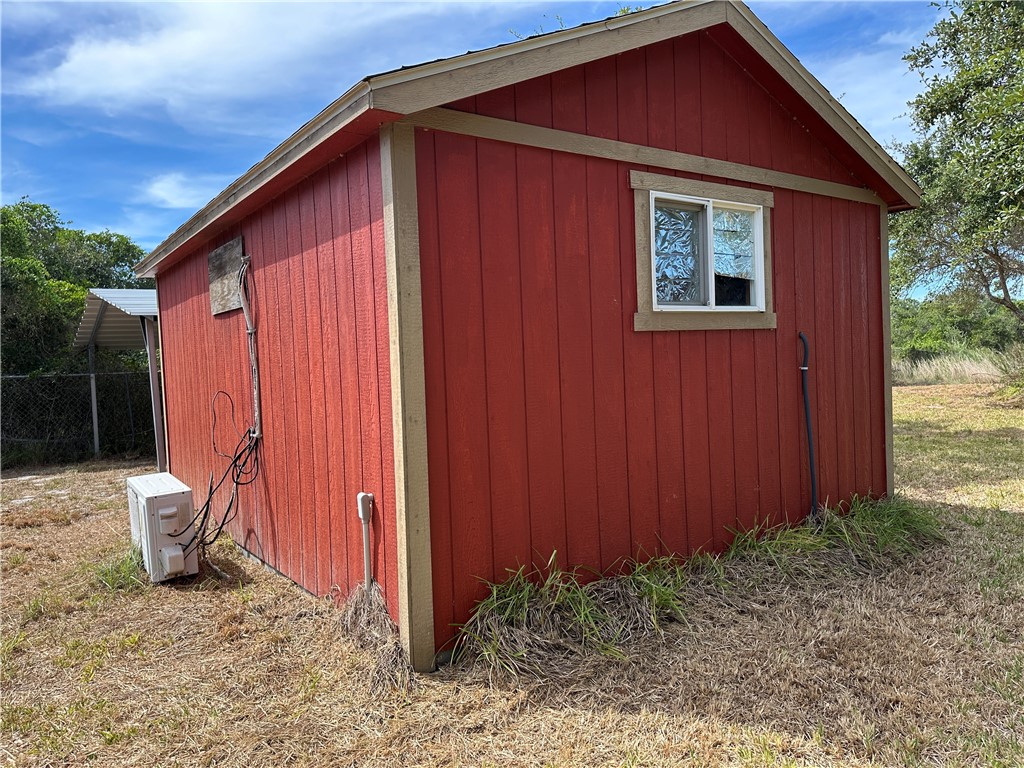 908 Jacoby Lane Aransas Pass, TX 78336 - Photo 21 of 27 a backyard of a house with chairs and wooden fence