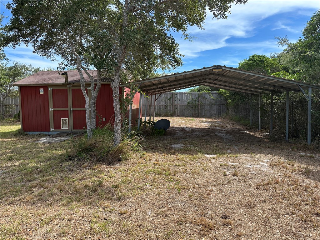 908 Jacoby Lane Aransas Pass, TX 78336 - Photo 22 of 27 a backyard of a house with lots of green space