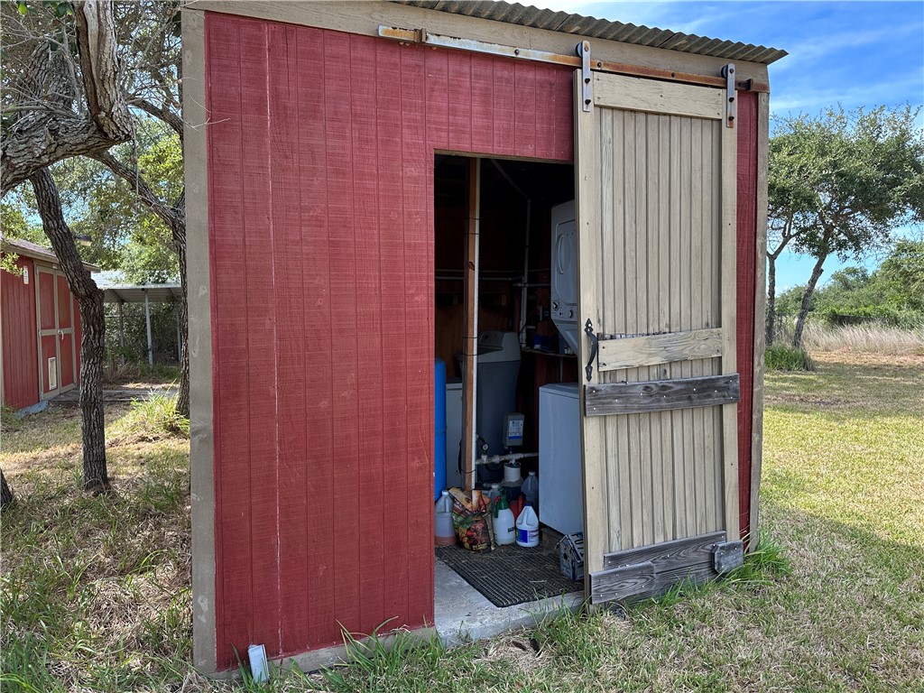 908 Jacoby Lane Aransas Pass, TX 78336 - Photo 23 of 27 a view of a house with a small yard and large tree