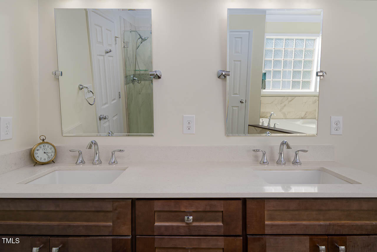 1059 Torrence Drive Apex, NC 27502 - Photo 20 of 49 a bathroom with a sink and a mirror