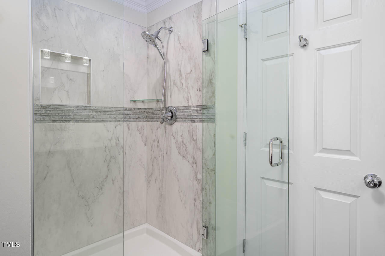 1059 Torrence Drive Apex, NC 27502 - Photo 22 of 49 a bathroom with a shower and a glass door shower