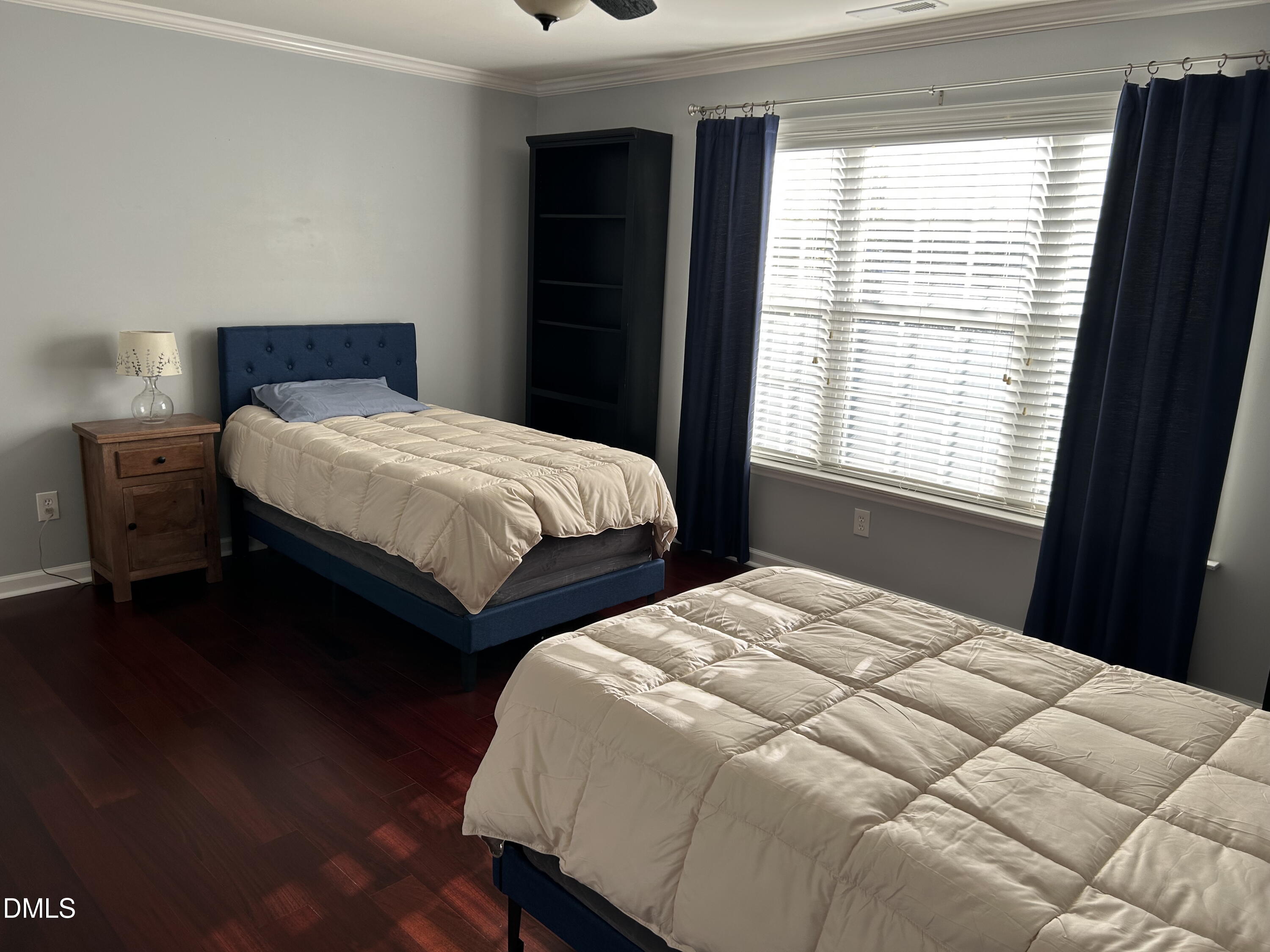 1059 Torrence Drive Apex, NC 27502 - Photo 24 of 49 a bedroom with two beds and wooden floor