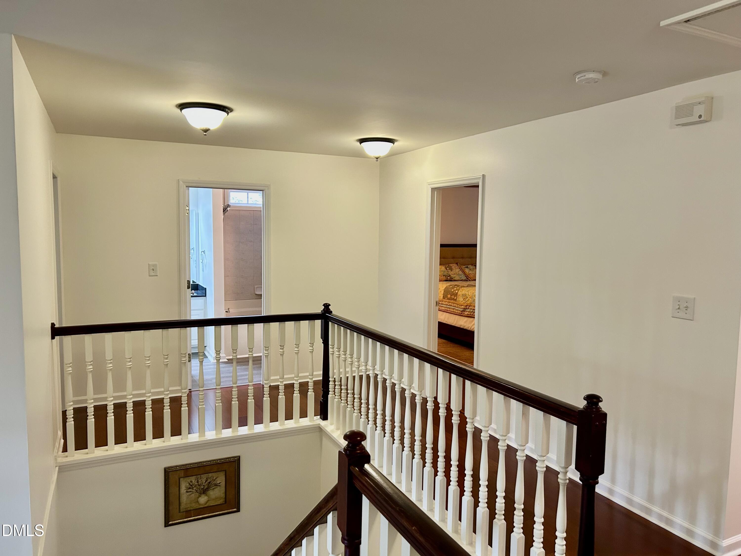 1059 Torrence Drive Apex, NC 27502 - Photo 29 of 49 a view of a hallway with wooden floor and staircase