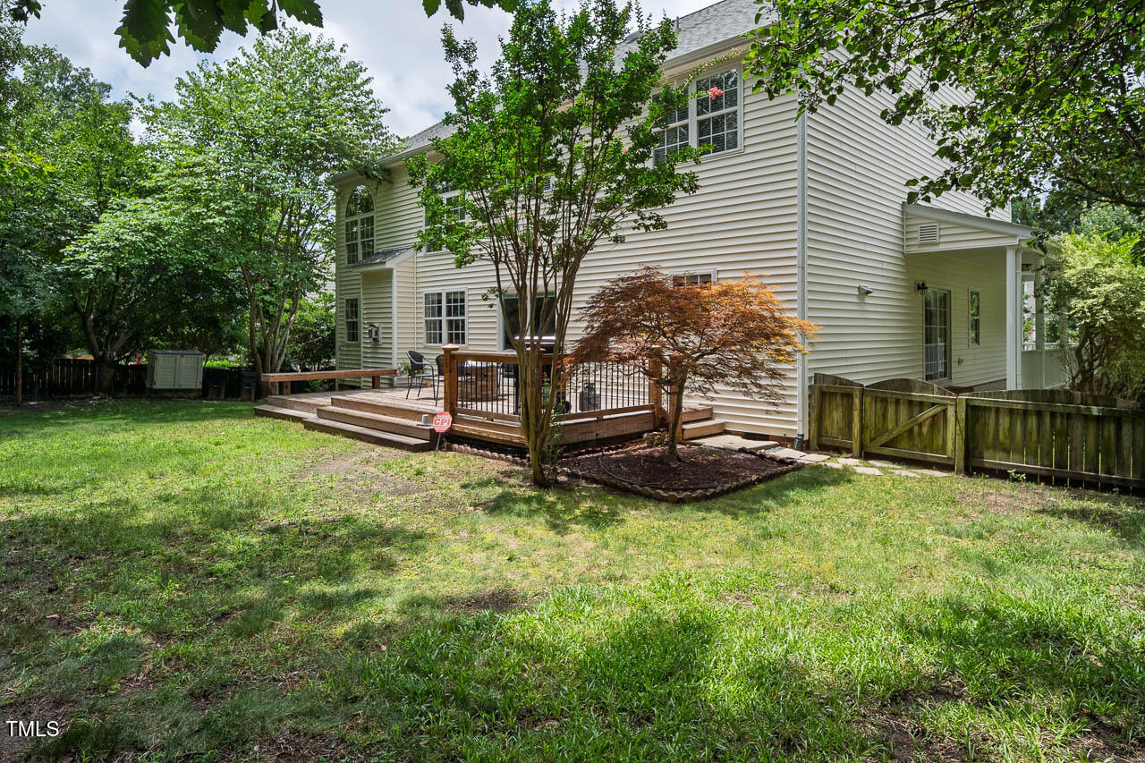 1059 Torrence Drive Apex, NC 27502 - Photo 39 of 49 a view of a house with backyard and a tree