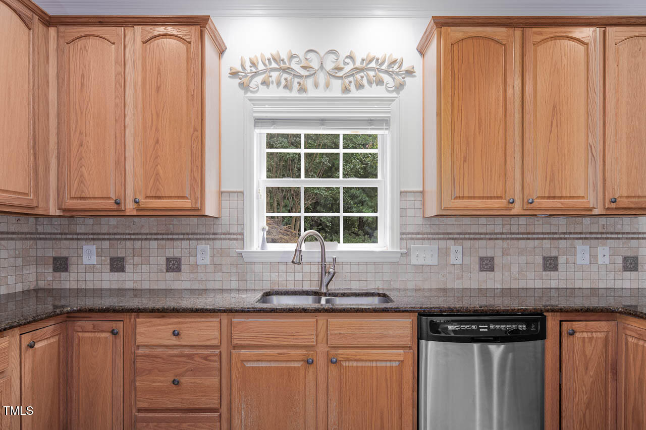 1059 Torrence Drive Apex, NC 27502 - Photo 5 of 49 a kitchen with granite countertop white cabinets and sink