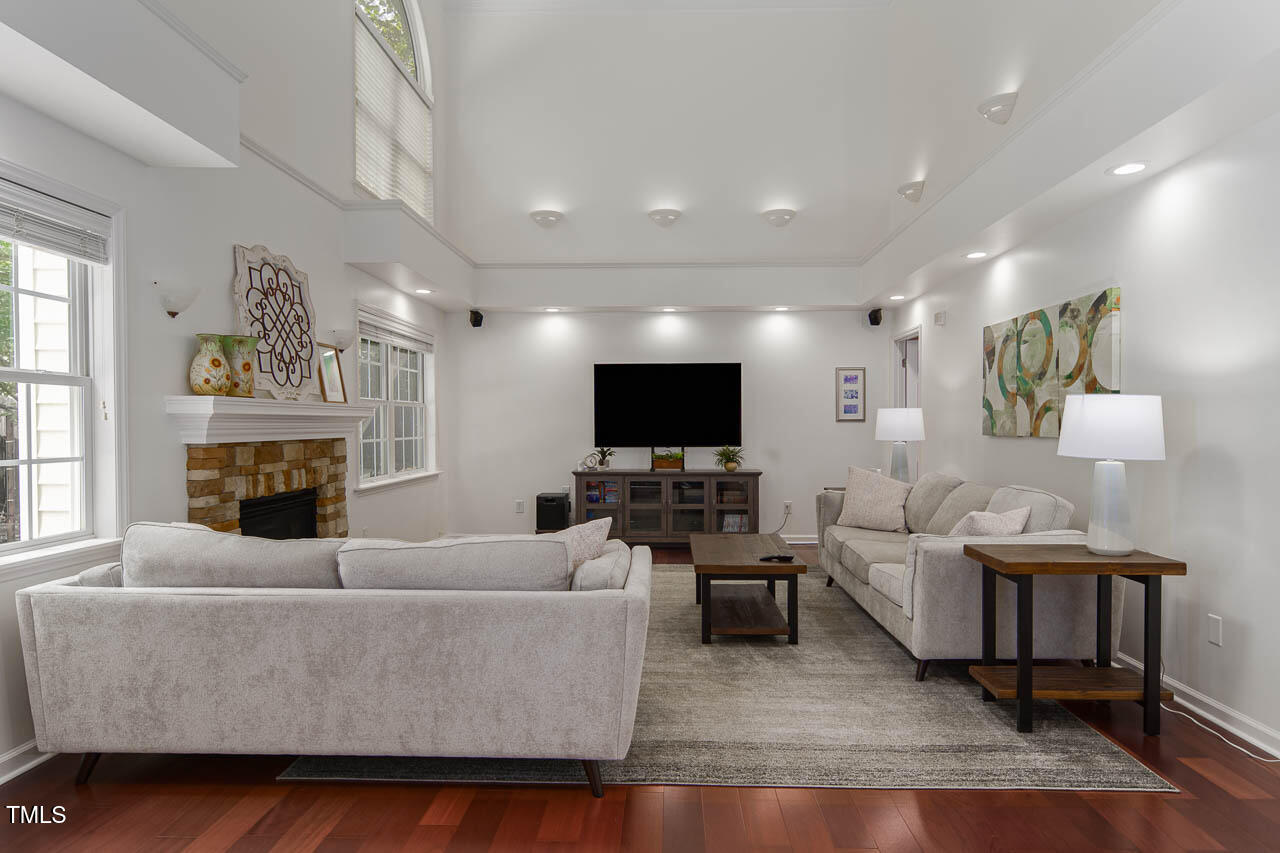 1059 Torrence Drive Apex, NC 27502 - Photo 8 of 49 a living room with furniture a fireplace and a flat screen tv