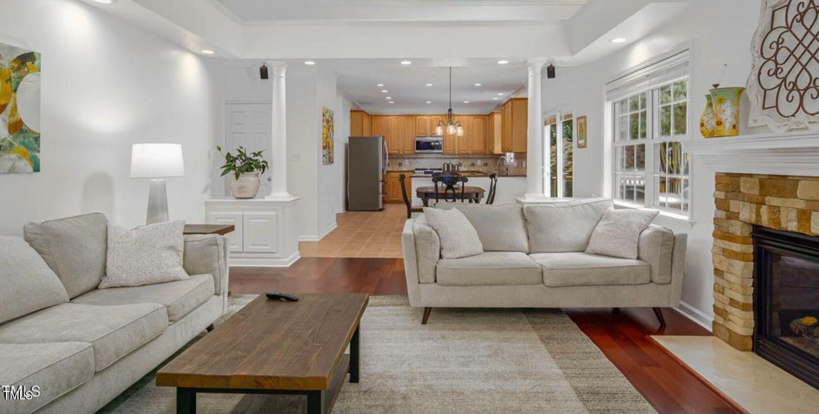 1059 Torrence Drive Apex, NC 27502 - Photo 10 of 49 a living room with furniture kitchen view and a chandelier