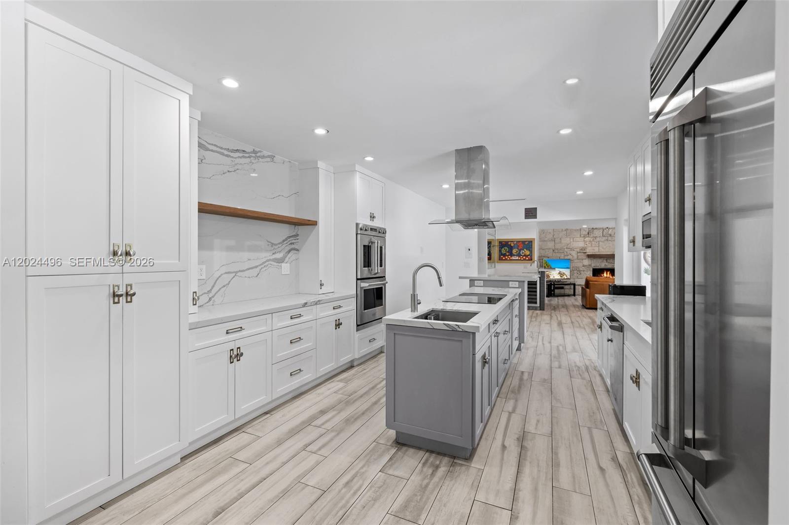 6875 North Cartee Road Palmetto Bay, FL 33158 - Photo 10 of 42 a open kitchen with white cabinets and stainless steel appliances
