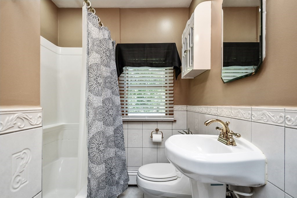 146 South Row Road Lunenburg, MA 01462 - Photo 17 of 32 a bathroom with a sink a toilet and a mirror