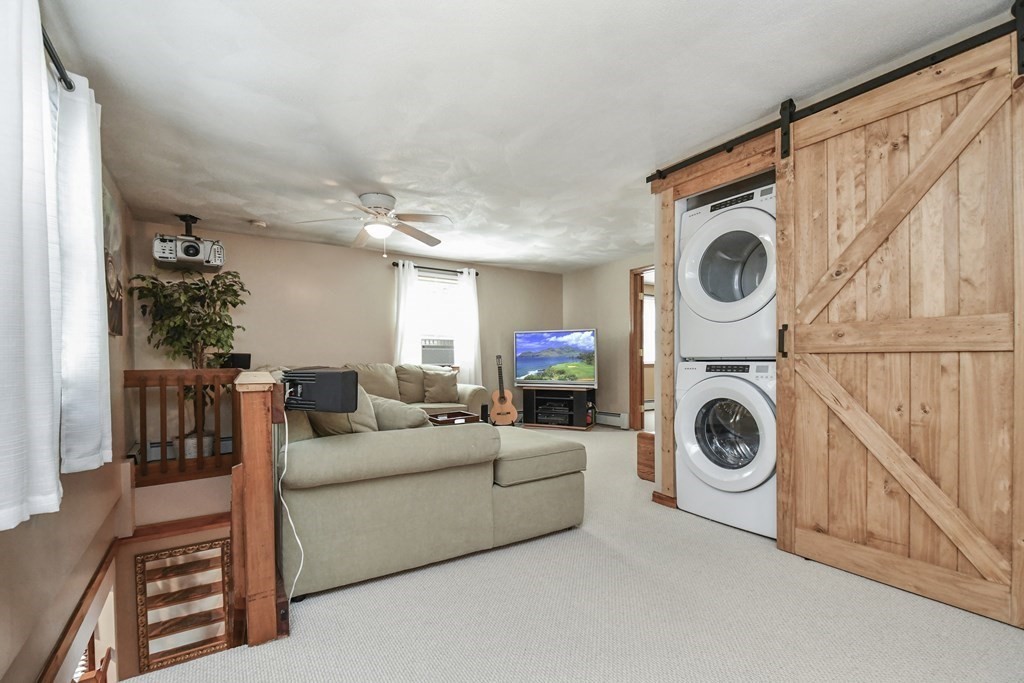 146 South Row Road Lunenburg, MA 01462 - Photo 18 of 32 a living room with furniture a washer and dryer