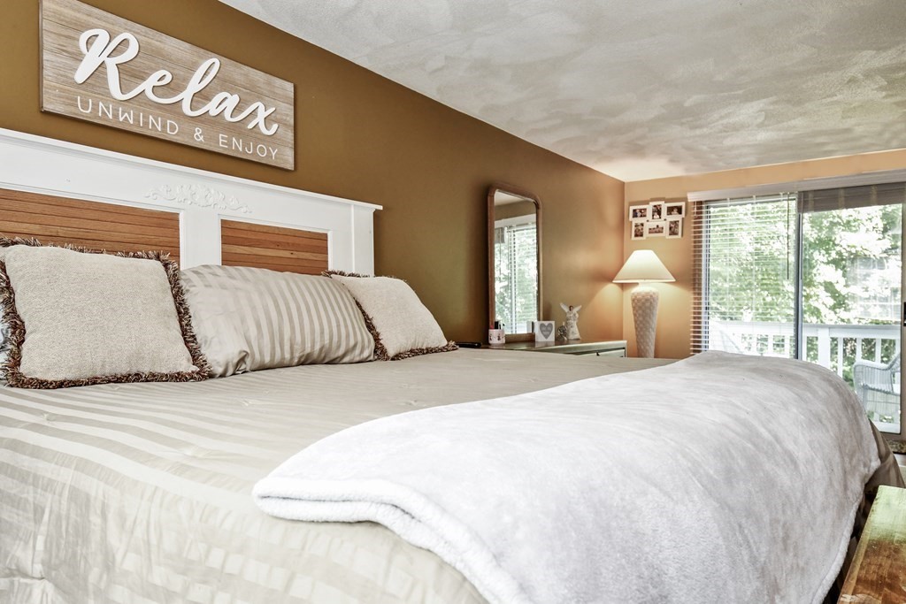 146 South Row Road Lunenburg, MA 01462 - Photo 23 of 32 a large bed sitting in a bedroom next to a window