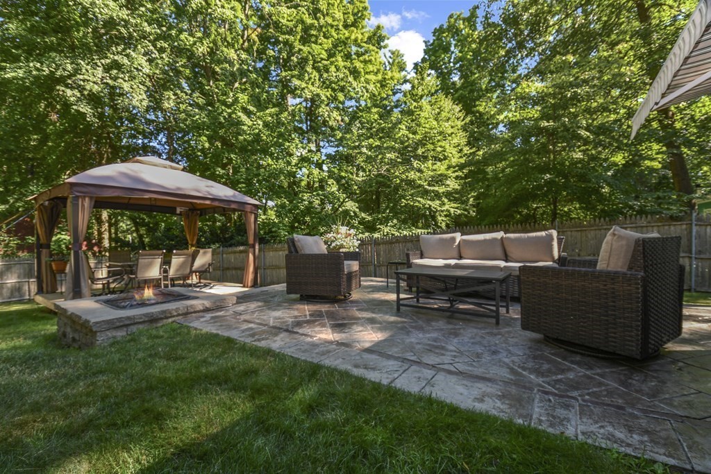 146 South Row Road Lunenburg, MA 01462 - Photo 30 of 32 a view of a patio with table and chairs under an umbrella