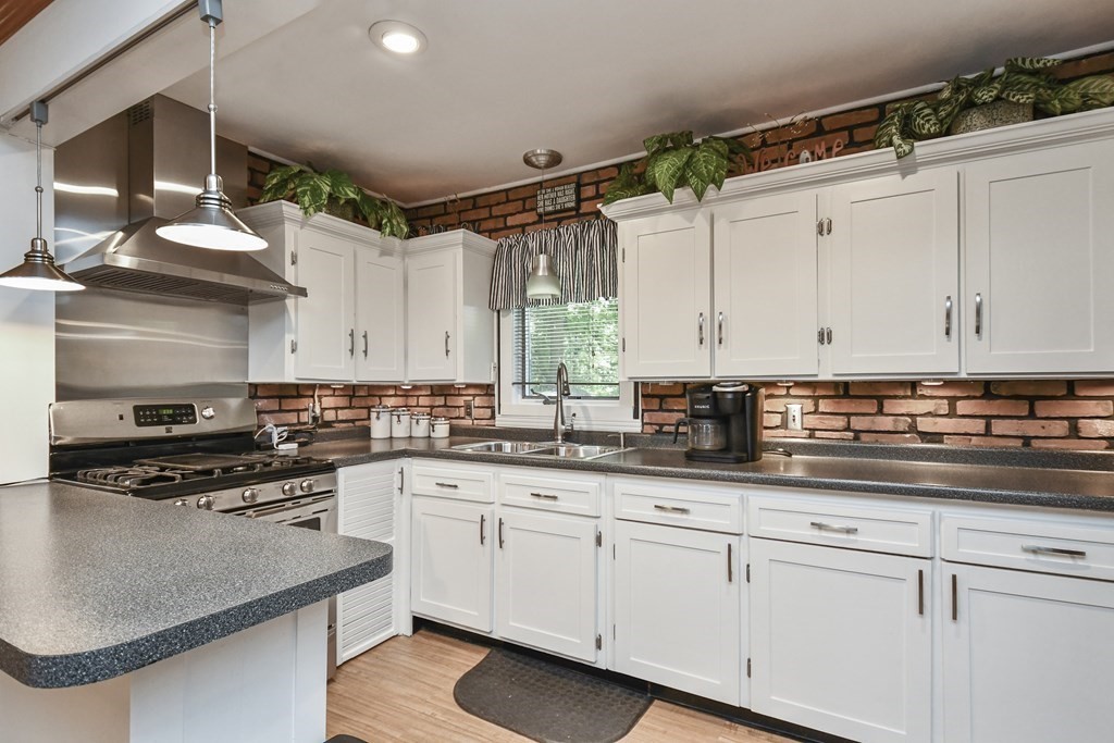146 South Row Road Lunenburg, MA 01462 - Photo 10 of 32 a kitchen with stainless steel appliances granite countertop a stove a sink and white cabinets