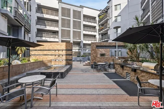 a view of a swimming pool with outdoor seating