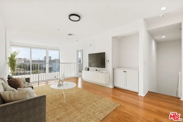 a living room with furniture tv and a flat screen tv