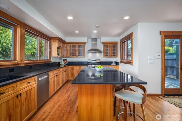 a large kitchen with granite countertop lots of counter space and windows