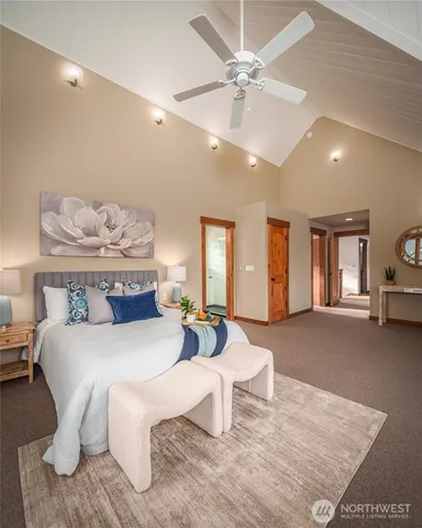 a bedroom with a large bed and a chandelier