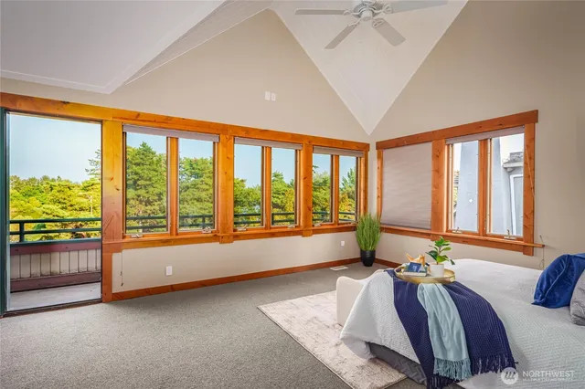 a spacious bedroom with a large bed and a large window