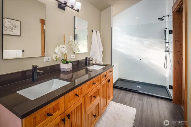 a bathroom with double vanity sink and a mirror