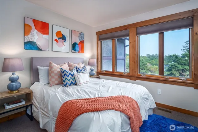 a bedroom with bed and wooden floor