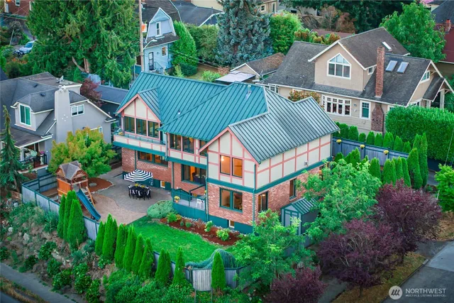 an aerial view of multiple houses with a yard