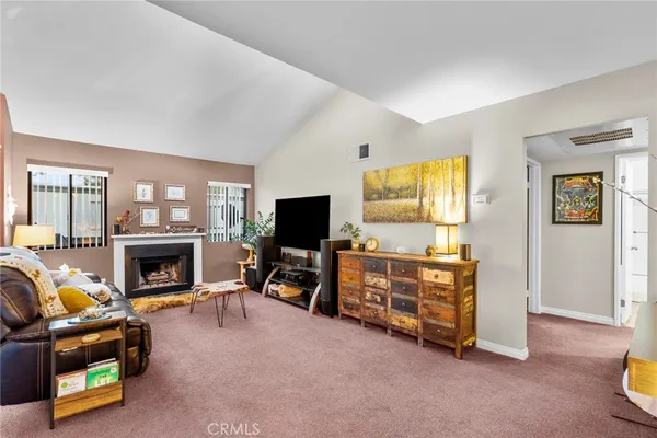 a living room with furniture and a flat screen tv with wooden floor
