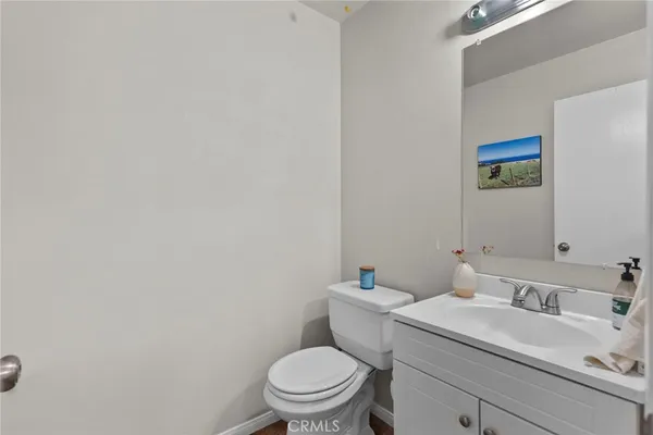 a bathroom with a sink mirror vanity and toilet