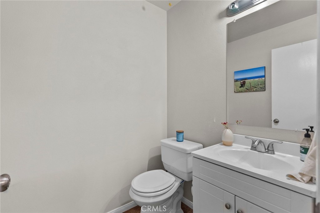 6490 Twin Cir Lane Simi Valley, CA 93063 - Photo 25 of 28 a bathroom with a sink mirror vanity and toilet