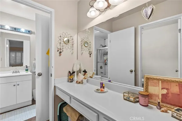a bathroom with a sink vanity granite and a mirror