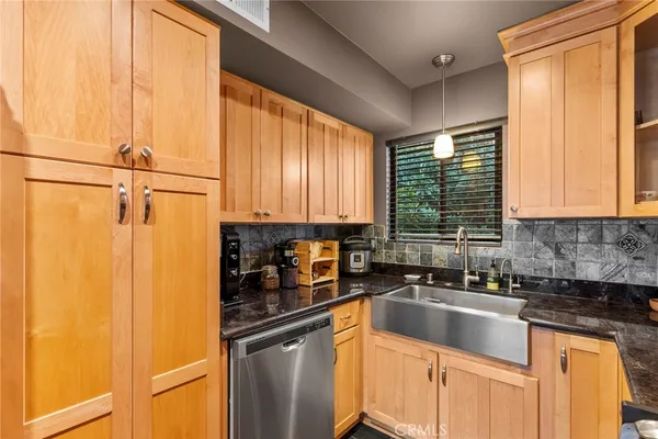 a kitchen with a sink a counter top space cabinets and a window
