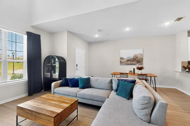 a living room with furniture rug and window