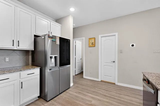 a kitchen with stainless steel appliances a refrigerator and cabinets