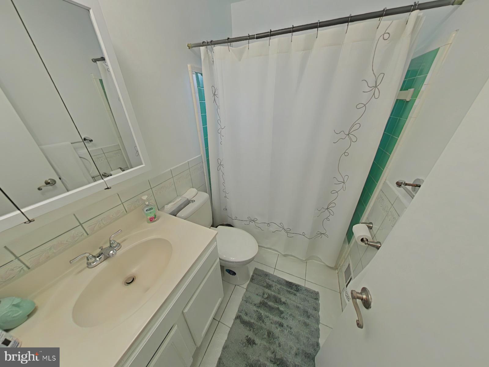 12807 Crisfield Road Silver Spring, MD 20906 - Photo 18 of 30 a bathroom with a sink and a mirror