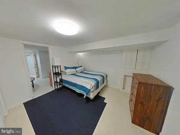 a bedroom with a bed and a mirror
