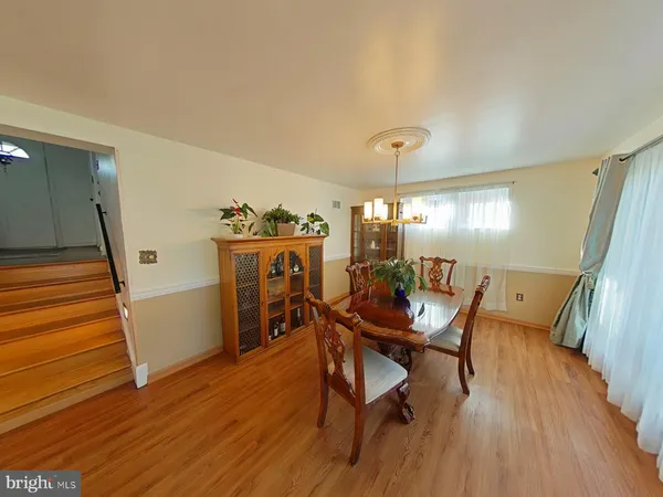 a dining room with furniture and wooden floor