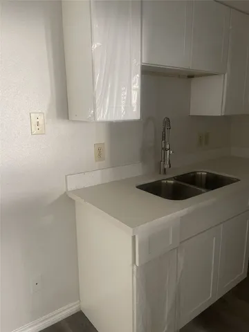 a kitchen with a sink and cabinets