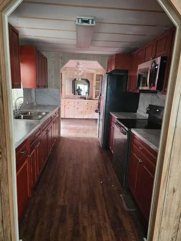 a kitchen with granite countertop a stove and a refrigerator