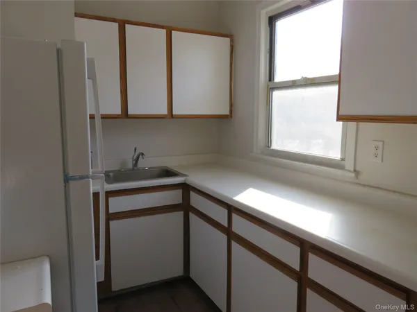 a kitchen with a refrigerator sink stove and cabinets