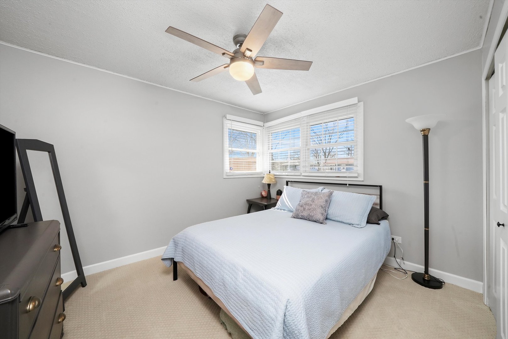 3908 Owl Drive Rolling Meadows, IL 60008 - Photo 21 of 36 a bedroom with a large bed and a chandelier