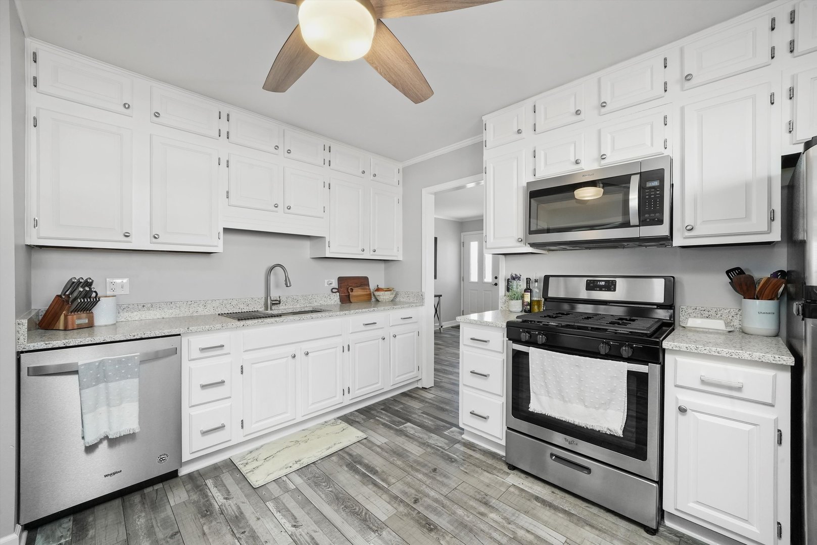 3908 Owl Drive Rolling Meadows, IL 60008 - Photo 7 of 36 a kitchen with granite countertop white cabinets white stainless steel appliances and a sink