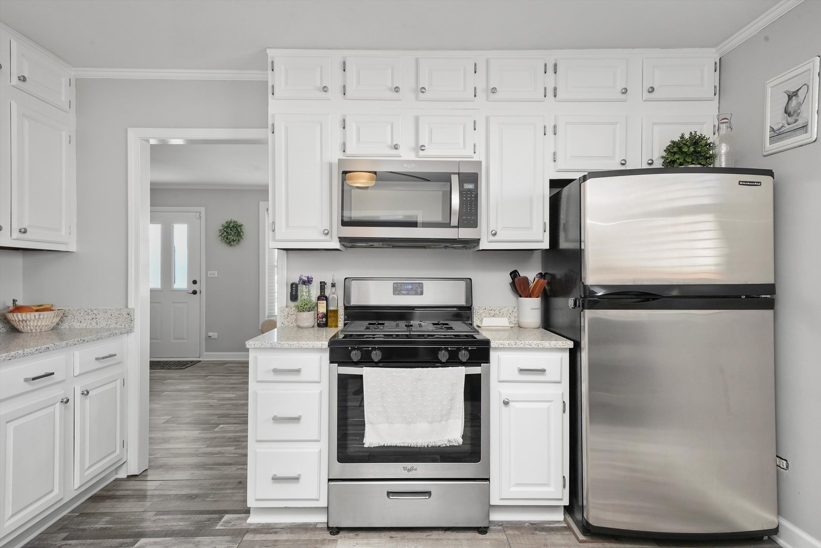 3908 Owl Drive Rolling Meadows, IL 60008 - Photo 9 of 36 a kitchen with granite countertop white cabinets and white appliances